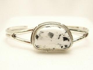 White Buffalo Turquoise Set in heavy gauge Sterling Silver. This Beautiful Stone is formed from the minerals Calcite and Iron. It is mined near Tonopah Nevada. Created by Navajo Artist Kathy Yazzie. Signed.
