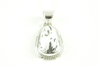 White Buffalo Turquoise set in Sterling Silver Pendant. This Beautiful Stone is formed from the minerals Calcite and Iron. It is mined near Tonopah Nevada. Free 18" Sterling Silver Chain with Purchase of Pendant. Created by Navajo Artist John Nelson. Signed.
