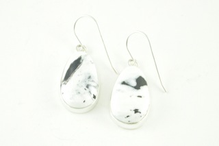 White Buffalo Turquoise set in Sterling Silver French Wire Earrings. This Beautiful Stone is formed from the minerals Calcite and Iron. It is mined near Tonopah Nevada.  Created by Navajo Artist Kathy Yazzie. Signed.
