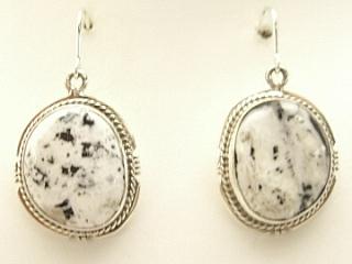 White Buffalo Turquoise set in Sterling Silver French Wire Earrings. This Beautiful Stone is formed from the minerals Calcite and Iron. It is mined near Tonopah Nevada. Created by Navajo Artist Kathy Yazzie. Signed.  
