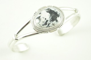 White Buffalo Turquoise set in heavy gauge Sterling Silver Bracelet. This Beautiful Stone is formed from the minerals Calcite and Iron. It is mined near Tonopah Nevada. Created by Navajo Artist Margaret Platero. Signed.
