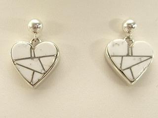 White Buffalo Turquoise inlaid in Sterling Silver Post Earrings. Stunning Heart Earrings with Storyteller Design on the reverse side. This Beautiful Stone is formed from the mineral Magnesite. It is mined near Elko Nevada. Designed by Navajo Artist Calvin Begay.
