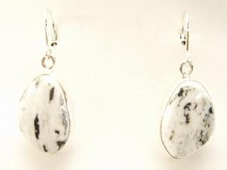 White Buffalo Turquoise set in Sterling Silver French Wire Earrings. This Beautiful Stone is formed from the minerals Calcite and Iron. It is mined near Tonopah Nevada. Created by Navajo Artist Kathy Yazzie. Signed.