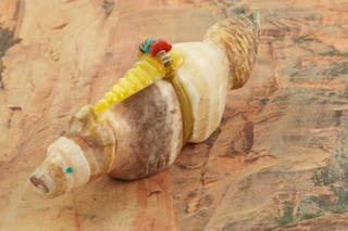 Zuni Bobcat Fetish created by Zuni Artist Peter Gasper. Signed by the artist. Carved from Banded Onyx with Genuine Turquoise, Mother of Pearl and Coral Accents.