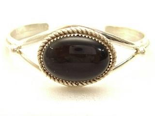 Genuine Black Onyx set in Sterling Silver Bracelet.
Created by Navajo Artist 
Edison Etsitty. Signed E. 

