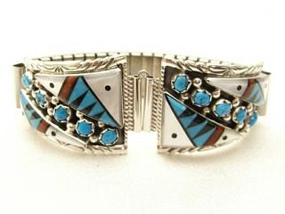 Authentic Native American Watch. The watch tips are a work of art. Genuine Sleeping Beauty Turquoise, Mother of Pearl, Coral & Jet inlaid in Sterling Silver with 5 Sleeping Beauty stones set between the inlay in each watch tip. Watch Tip includes expandable band. Created by Navajo Artist Ella Cowboy.