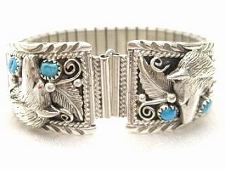 Genuine Sleeping Beauty Turquoise set in Sterling Silver. Mens Watch Tips with expandable band. Wolf Design. Created by Navajo Artist Rita Dawes.