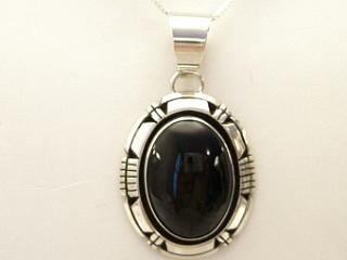 Genuine Black Onyx set in Sterling Silver Pendant. Free 18" Sterling Silver Chain with purchase of pendant. Created by Navajo Artist Rita Touchine. Signed.