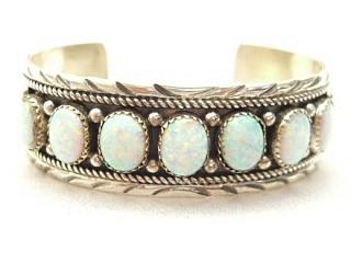 7 Beautiful Fire & Ice Lab Opal Stones set in Sterling Silver Bracelet. Heavy gauge Sterling Silver. Created by Navajo Artist Edison Etsitty. Signed E.