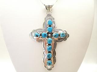 Genuine Sleeping Beauty Turquoise set in Sterling Silver Cross. FREE 18" Sterling Silver Chain with purchase. Created by Navajo Artist Frank Arviso. Signed A.