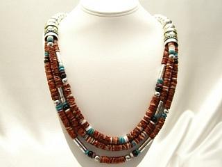 3 Strand Necklace. Assorted Genuine Gemstones Necklace. Featuring Spiny Oyster Shell, Turquoise and Black Onyx with Sterling Silver and Gold filled Barrels. Sterling Silver Beads & Clasp. Created by Navajo Artist Tommy Singer.