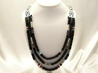 3 Strands of Genuine Assorted Gemstones Necklace. Featuring Black Onyx, Turquoise, Howlite, Coral and Jasper with Sterling Silver Barrels, Beads & Clasp. Created by Navajo Artist Tommy Singer.