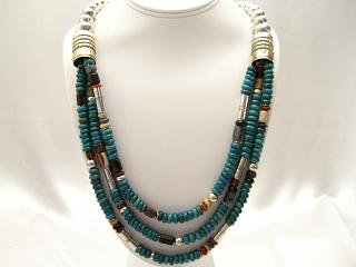3 Strand Necklace. Assorted Genuine Gemstones Necklace. Featuring Genuine Turquoise, Black Onyx, Jasper and Coral with Sterling Silver and Gold Filled Barrels. Sterling Silver Beads & Clasp. Created by Navajo Artist Tommy Singer.