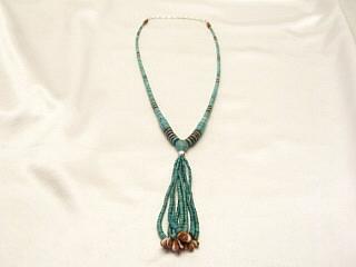 Genuine Turquoise and Spiny Oyster Shell Necklace with Sterling Silver Bead & Clasp. The double strands of Beads hanging from the necklace is called a Jocla, which is a Navajo word meaning Earrings. The Earrings were once often hung from the bottom of necklaces while riding, lest they be torn from the ear by a tree branch. Eventually they became a design element of the Necklace itself. The shell beads at the bottom of the Jocla are referred to as corn because of their resemblance to corn kernels. Created by Zuni Artist Susan Beal. This is a one of a kind necklace. The photo is of the necklace you will be receiving.