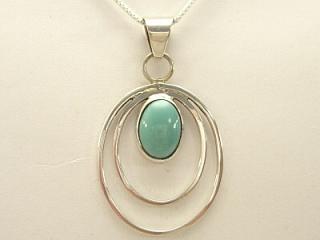 Genuine Turquoise set in  Sterling Silver Pendant. Free 18" Sterling Silver Chain with Purchase of Pendant. Created by Navajo Artist Ida Mc Cray. Signed IMC.