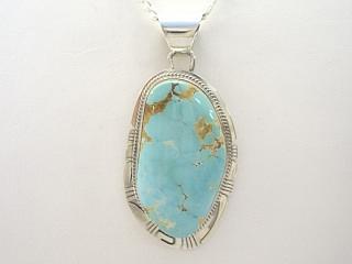 Genuine Royston Turquoise Stone  set in Sterling Silver Pendant. Beautiful Turquoise Stone.  The Royston Turquoise Mine is located in Nye County, Nevada. Free 18" Sterling Silver Chain with Purchase of Pendant. Created by Navajo Artist Phillip Sanchez. Signed