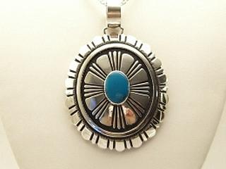Genuine Turquoise set in Sterling Silver Pendant on a 18" 3.5 mm Sterling Silver Spiga Design Chain. Created by Navajo Artist Tommy Singer. Signed.