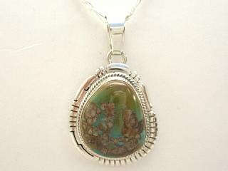 Genuine Royston Turquoise Stone set in Sterling Silver Pendant. The Royston Turquoise Mine is located in Nye County, Nevada. Free 18" Sterling Silver Chain with Purchase of Pendant. Created by Navajo Artist Milton Lee. Signed.