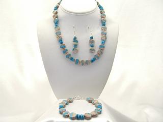 Genuine Boulder Turquoise with Sterling Silver Clasp. This Beautiful Set includes Necklace, Earrings and Bracelet. The cabochons are Boulder Turquoise, you can see the veins of Turquoise running through the host rock. The Boulder Turquoise Mine is located in northeast Nevada. It was discovered in 1970 by a Shoshone sheep herder. Production is small due to the remote location and winter weather. Boulder Turquoise is valued for both it's beauty and rarity. Navajo Made.