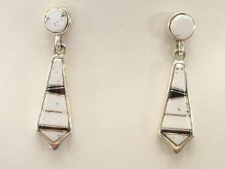 White Buffalo Turquoise and Jet inlaid in Sterling Silver Post Earrings. This Beautiful Stone is formed from the mineral Magnesite. It is mined near Elko Nevada. Designed by Navajo Artist Calvin Begay. Created by Navajo Artist Etta Lee.